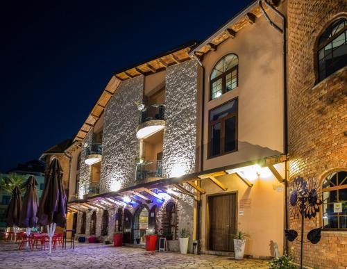 a building with lights on it at night at Rambuje Resort in Lezhë