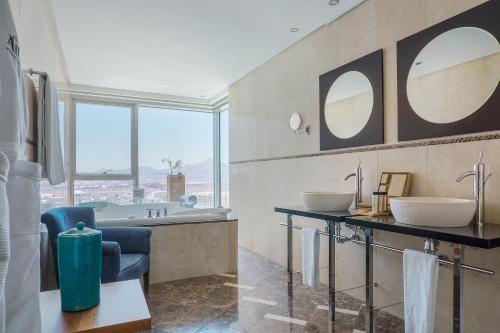 a bathroom with two sinks and a bath tub at Arrecife Gran Hotel & Spa in Arrecife