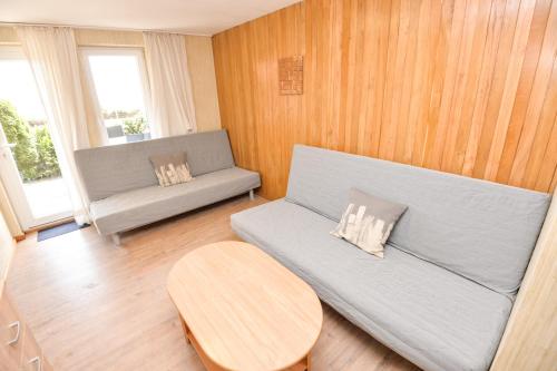 a living room with a couch and a table at Vila Baldininkas in Neringa