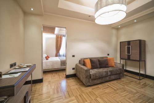 a living room with a couch and a bedroom at Solo Experience Hotel in Florence