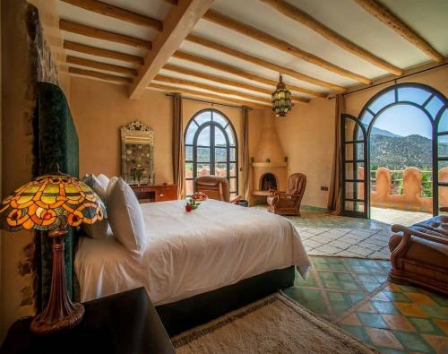 a bedroom with a bed in a room with windows at Tizi N'Ouirgane in Marrakesh