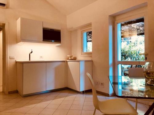 a kitchen with a counter and a table and a window at Villino I Pini in Marciana Marina