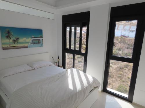 En eller flere senge i et værelse på Penthouse Seacoast