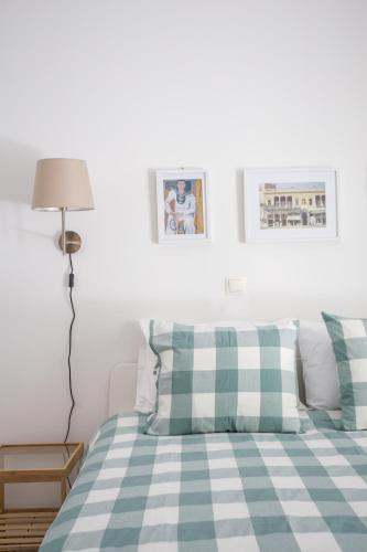 a bedroom with a bed with green and white pillows at Spacious Unique Luxurious Central in Thessaloniki