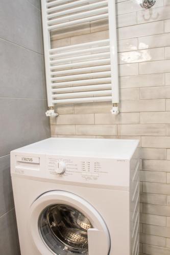 a washer and dryer in a bathroom with a window at Spacious Unique Luxurious Central in Thessaloniki