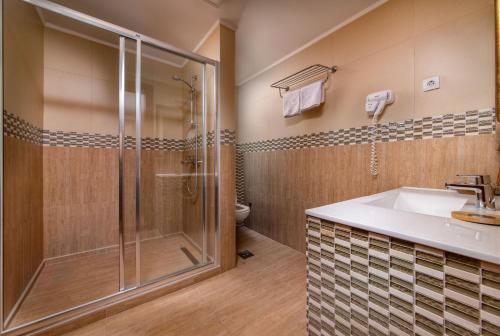 a bathroom with a shower and a sink at My Soul Resort in Knić