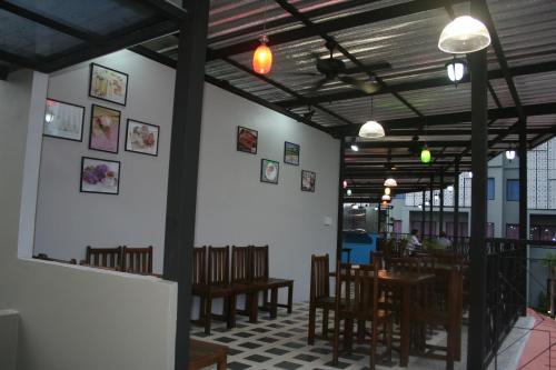 a dining room with tables and chairs in a restaurant at Dinar Lodge in Bang Tao Beach
