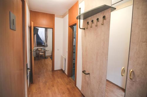 a corridor of a room with wood floors and a door at Penzion Pod Radnicí in Hustopeče