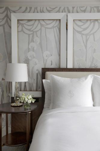 a bedroom with a bed and a table with a lamp at Four Seasons Boston in Boston