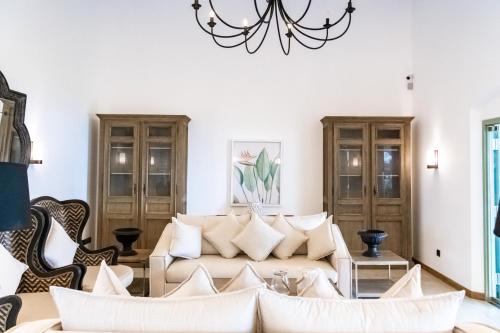 a living room with a couch and a chandelier at Angel Beach Unawatuna in Unawatuna
