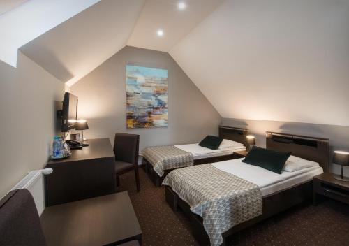 Posteľ alebo postele v izbe v ubytovaní Hotel Capitol