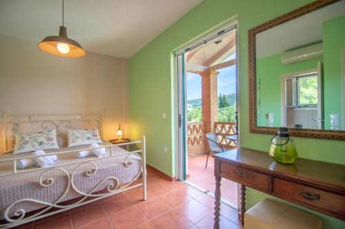 a bedroom with a bed and a mirror at Elegant Maisonettes Kalamaki in Kalamaki