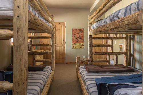a room with four bunk beds in a house at Moonlight Mountain Home-9 Indian Summer in Big Sky Mountain Village