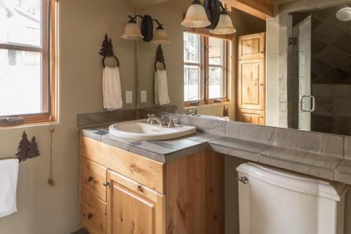 a bathroom with a sink and a mirror at Moonlight Mountain Home-9 Indian Summer in Big Sky Mountain Village