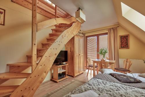 a bedroom with a loft bed and a staircase at Apartament 1010 m in Ząb