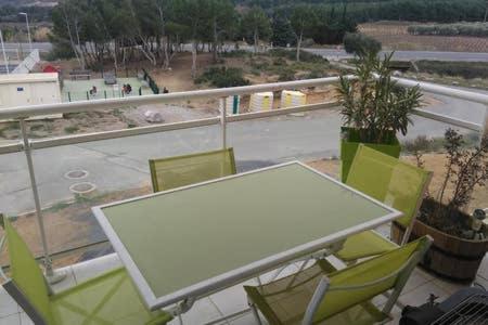 a table and chairs on a balcony with a view at Appartement Narbonne in Narbonne