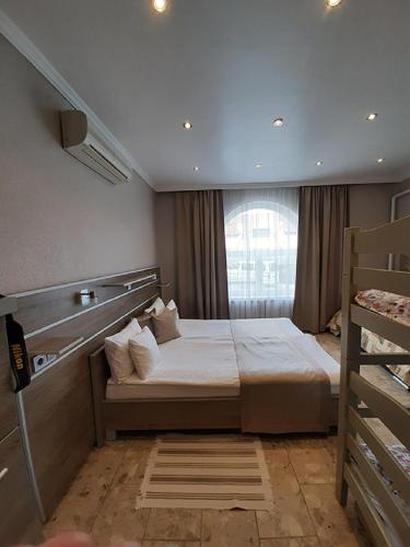 a bedroom with a bed and a bunk bed at Márvány Panzió in Hajdúszoboszló