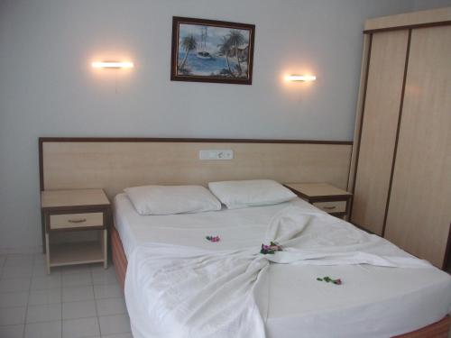 a hotel room with a bed with flowers on it at Delphin Hotel Side in Side