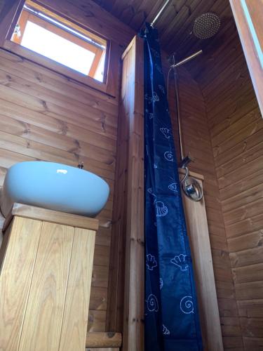 a bathroom with a sink and a window at Labrags Saulrieti in Jūrkalne