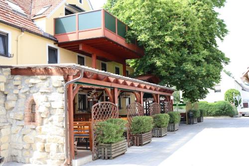 a restaurant with a balcony on the side of a building at Landsteakhaus in Marxheim