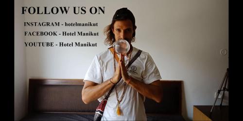 a man is singing into a magnifying glass at Hotel Manikut in Rishīkesh