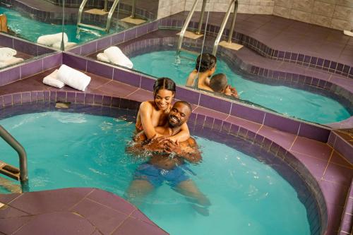 a man and woman in a swimming pool at Paradise Stream Resort in Cresco