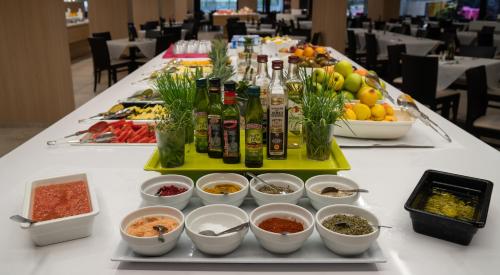 a table with a buffet of food and bottles of alcohol at Medplaya Hotel Rio Park in Benidorm