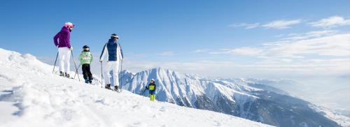 a group of people standing on top of a snow covered mountain at Tratterhof Mountain Sky Hotel in Maranza