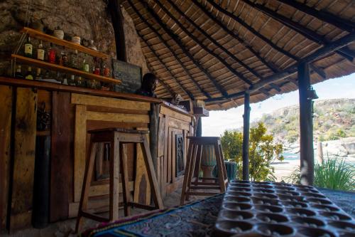 a bar with a counter and a stool at Mufasa Eco Lodge in Monkey Bay