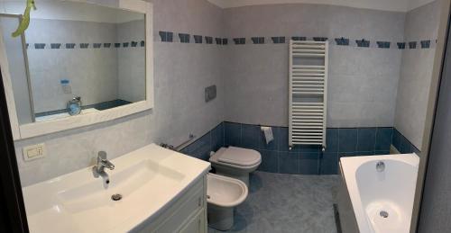 a bathroom with a sink and a toilet and a mirror at La porta del Sole in Seborga