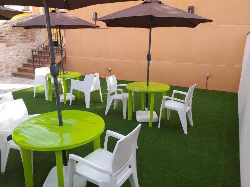 a group of tables and chairs with umbrellas at El Horno de Leopoldo in Hueva