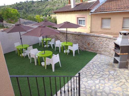 a group of tables and chairs with umbrellas at El Horno de Leopoldo in Hueva