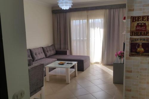 a living room with a purple couch and a table at One- bedroom apartment S3 in Vip Zone Sunny Lakes in Sharm El Sheikh