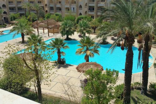 an aerial view of a resort pool with palm trees at One- bedroom apartment S3 in Vip Zone Sunny Lakes in Sharm El Sheikh