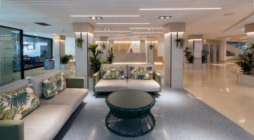 a lobby with couches and a table in a building at Medplaya Hotel Rio Park in Benidorm