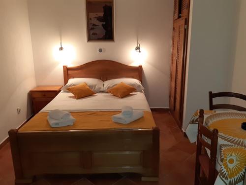 a bedroom with a bed with two hats on it at Zoro Apartments in Sveti Stefan