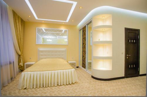 a bedroom with a bed and a skylight at Sweet Hall Hotel in Krasnodar