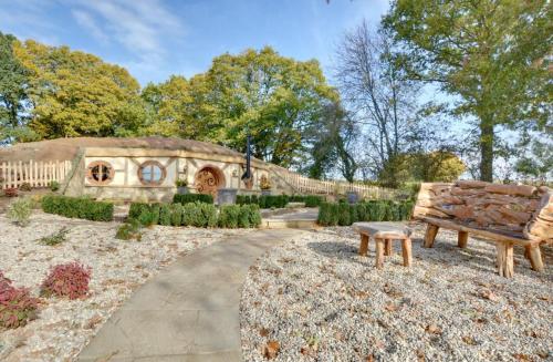 a bench in a garden in front of a building at Oastbrook Vineyard in Bodiam