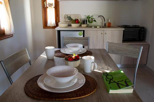 a table with plates and bowls on it in a kitchen at Sea and Creek in Katelios