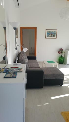 a living room with two beds and a table at Apartments Rolovina in Tivat
