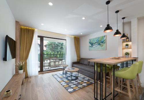 a living room with a couch and a table at Vip Casa Club Zlatibor in Zlatibor