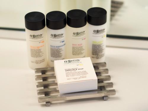 a group of four vitamin bottles on a shelf at The Study at Yale, Study Hotels in New Haven
