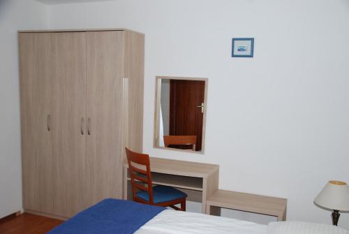 Ένα ή περισσότερα κρεβάτια σε δωμάτιο στο Apartmani Dragica