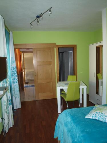a bedroom with a bed and a desk and a table at Ruhe am See in Presseggersee