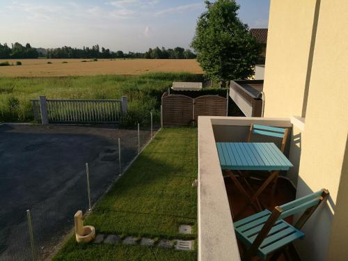 a balcony with a table and chairs and a field at Ca' Nadia in Campalto