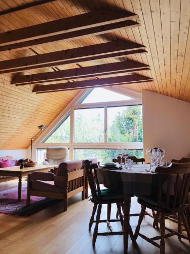 a dining room with a table and a large window at Jizerka in Unterwasser