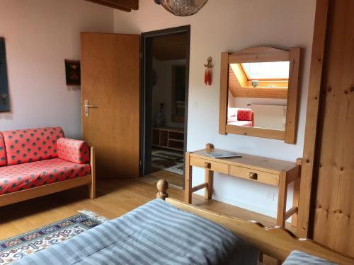 a bedroom with a bed and a mirror and a chair at Jizerka in Unterwasser