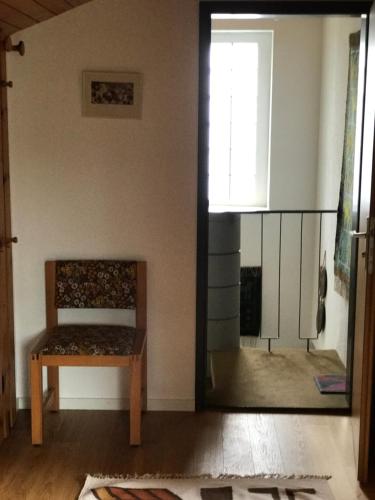 a living room with a bench and a mirror at Jizerka in Unterwasser