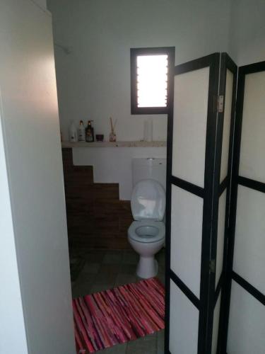 a bathroom with a white toilet in a room at Nice suite Nahariyya in Nahariyya