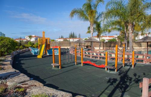 a playground with a slide in a park at B27 - LuzBay 2 Bed Apartment in Luz